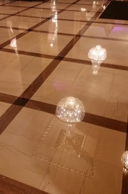 Hilton Milwaukee City Center floor reflecting distant chandelier and woodwork in fine detail